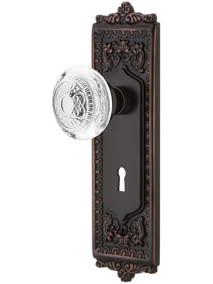 Egg and Dart Door Set with Keyhole and Matching Crystal-Glass Knobs in Timeless Bronze.